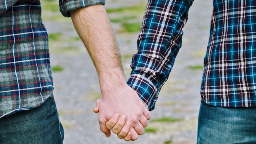 Gay couple holding hands istock.jpg
